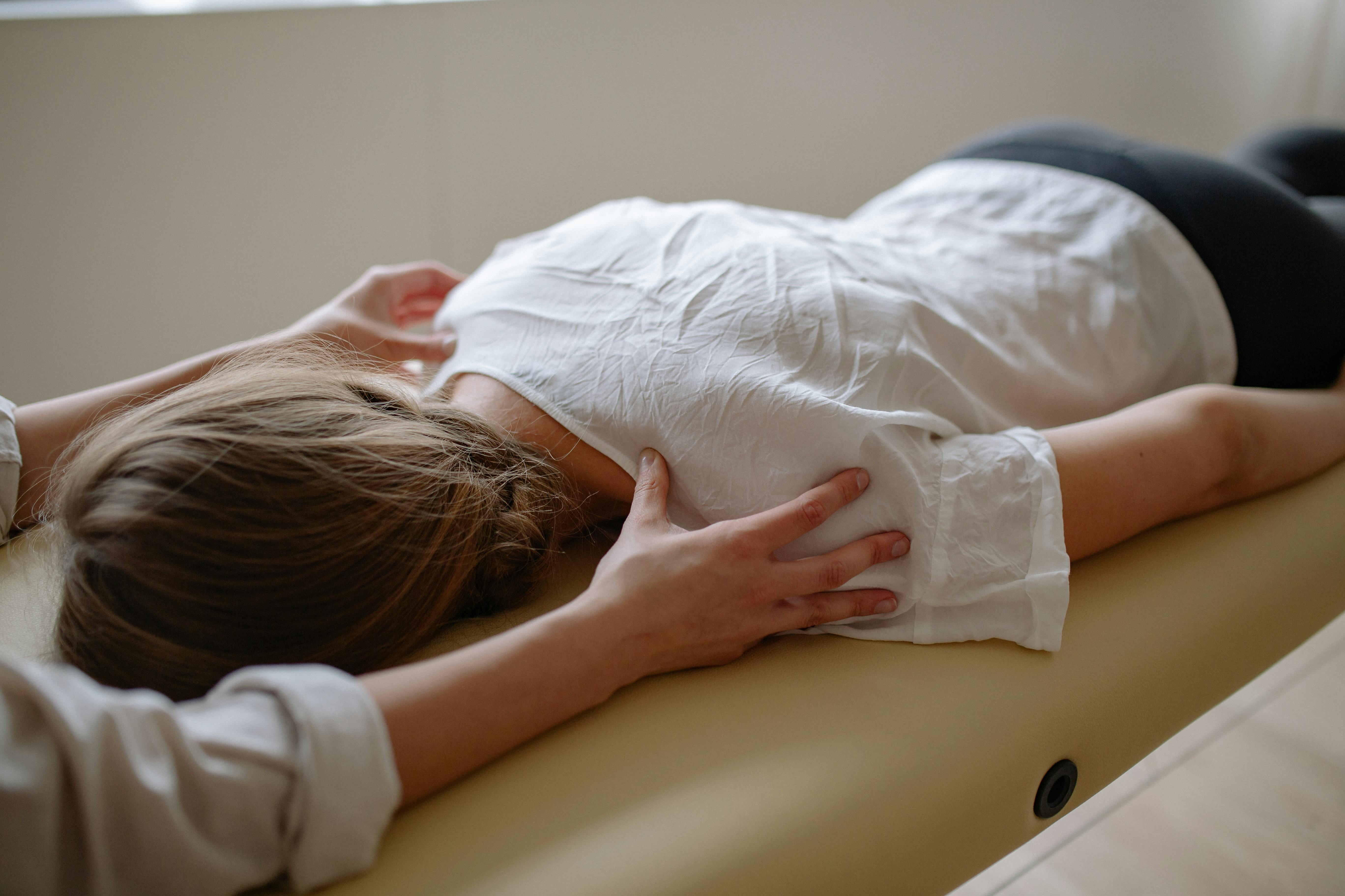 Lady receiving massage treatment lying face down on a table